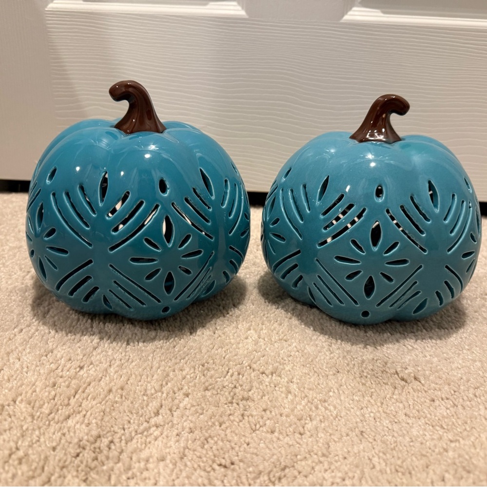 Two turquoise blue pumpkin lights